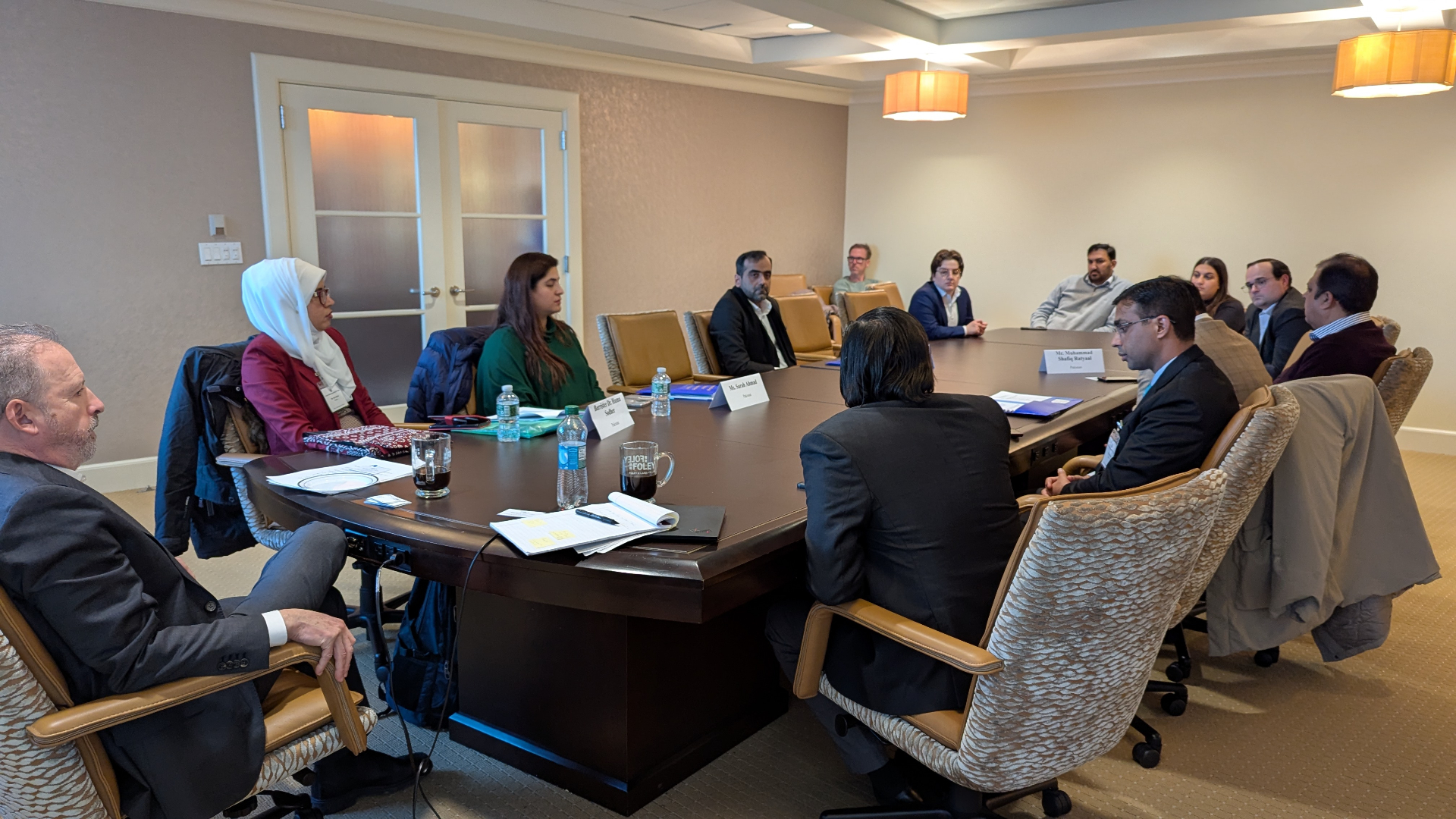 International delegation in roundtable discussion at a Boston conference room